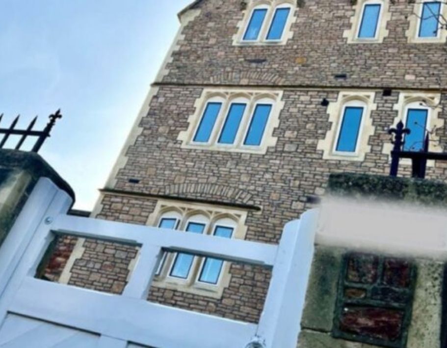 converted building into flats with white gate